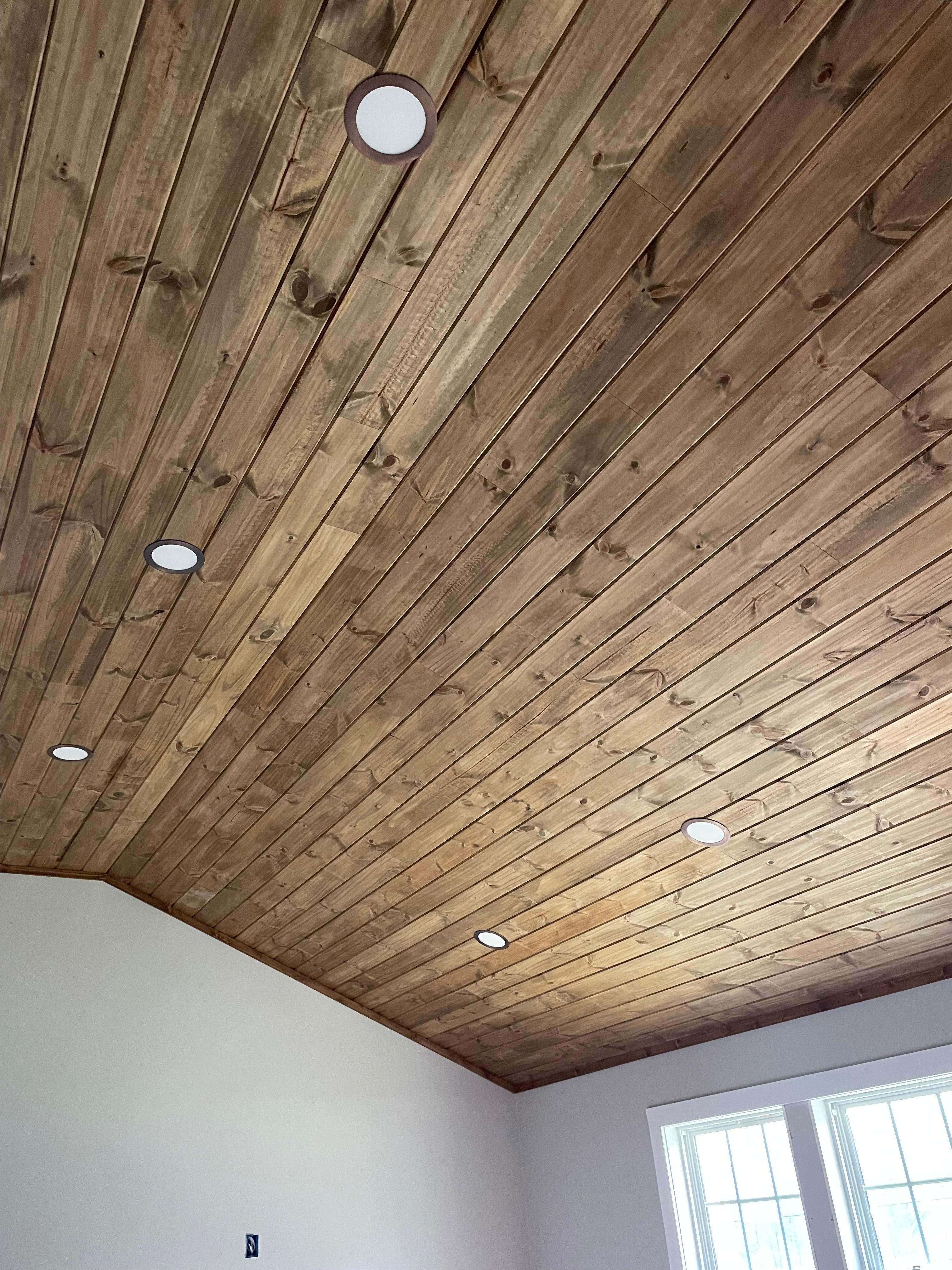 Stained longleaf yellow pine tongue and groove ceiling in indoor room